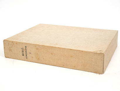 Joan Miró Lithographe Volume I Book: Joan Miró Lithographs Volume I book. Michel Leiris and Fernand Mourlot, published 1972. Compiles works and lithographs of the artist's legacy with a canvas hardcover. Measures 14.25"H x 11.25"W x 2.7