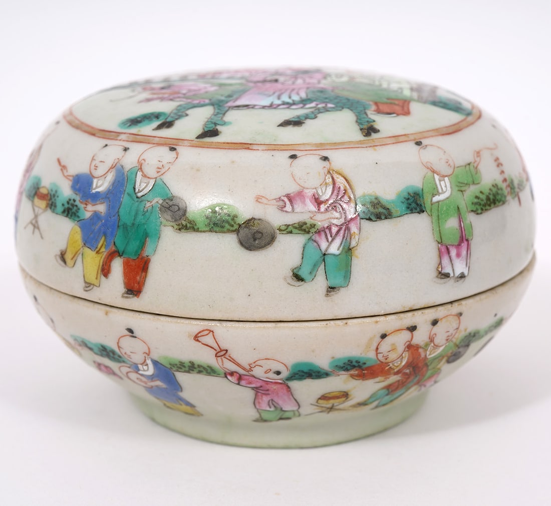 Chinese Hand-Painted Round Trinket Box: Chinese hand-painted round trinket box, decorated with many figures of children, some playing musical instruments. Measures 2.25"H x 3.5"W. Condition report: Minor chip to inner rim, please examine al