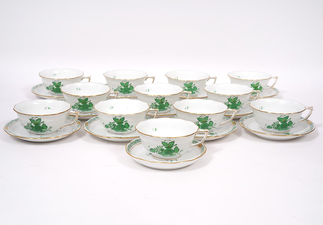 12 Herend Chinese Bouquet Green Cups & Saucers: 12 Herend Chinese Bouquet Green Tea Cups have peony designs surrounded with 24K gold trim, accents and a slightly scalloped rim. Marked on underside 734/AV and measures 2"H x 4.25"W (5"W with handle).