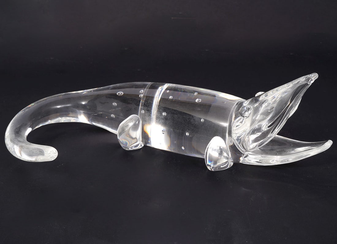 Steuben Glass Alligator or Crocodile: Steuben glass alligator or crocodile figure is signed on underside. Measures - 10.5"L x 6.5"W x 3.5"H. Condition report: Good condition, please see all photos. Contact C. Biddle Auction Gallery for mo