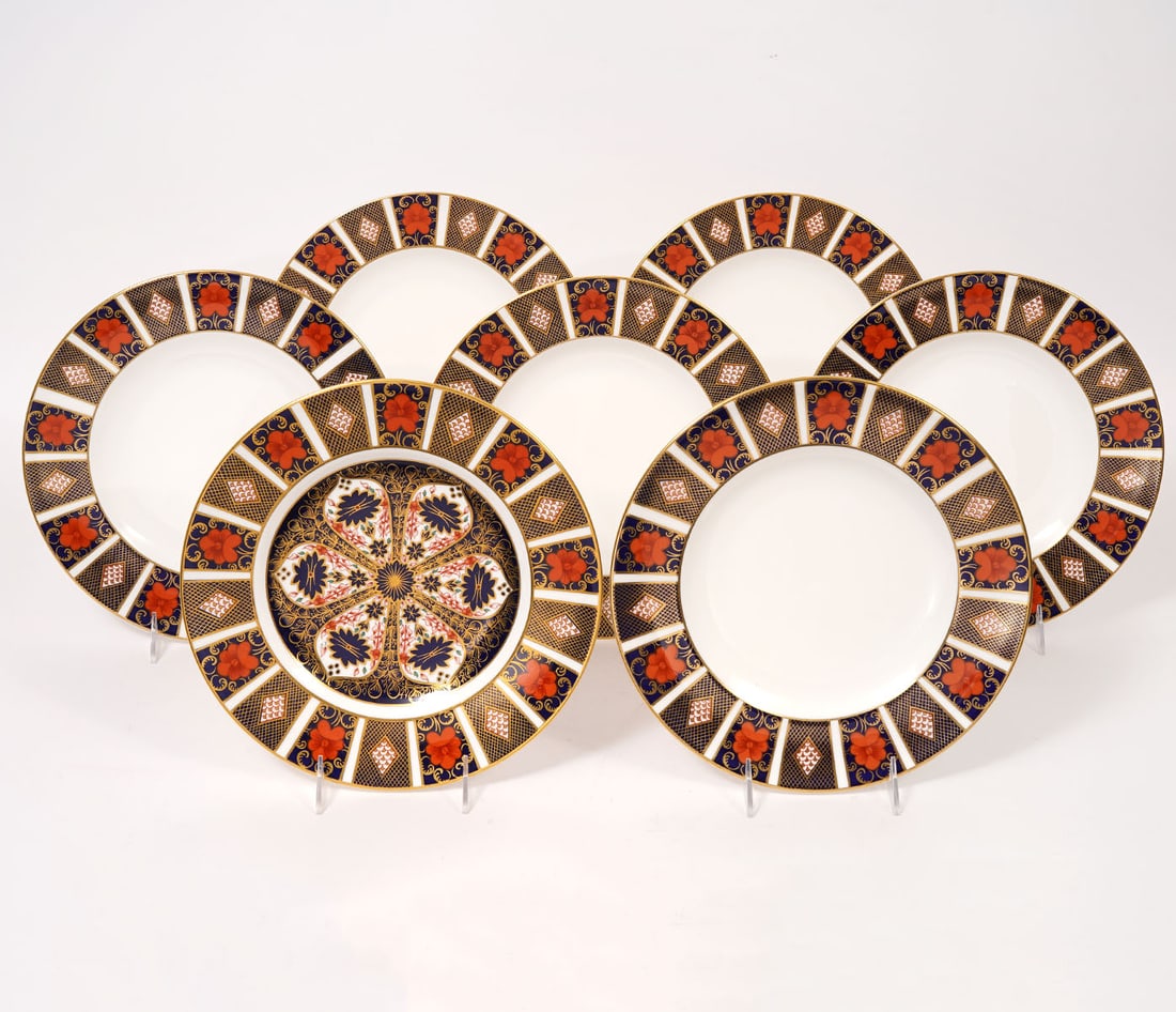 Seven 'Old Imari' Royal Crown Derby Dinner Plates: Seven 'Old Imari' Royal Crown Derby dinner plates measure 10.5"W, marked #1128 on underside. Plates are trimmed in 22 karat yellow gold. Condition report: good condition, please see all photos. Contac