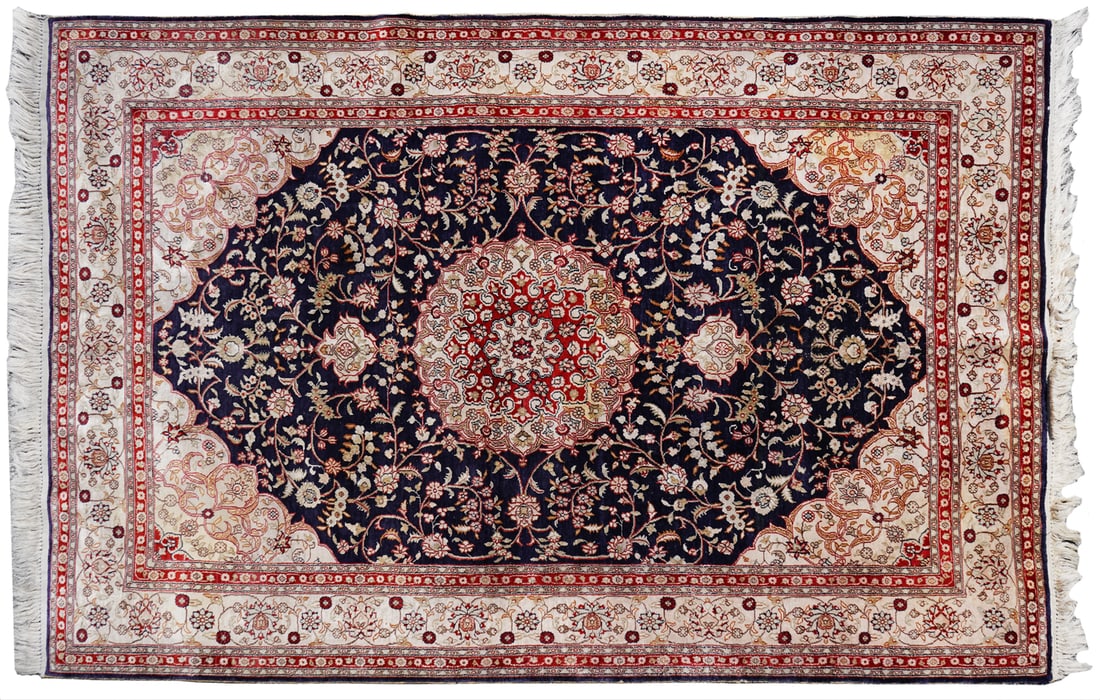 Persian Isfahan Rug: Persian Isfahan Rug. Features deep indigo field densely decorated with palmettes, floral sprays, and curvilinear vine work in ivory, deep reds, and gold. Measures 75"L x 49"W. Condition report: wear c