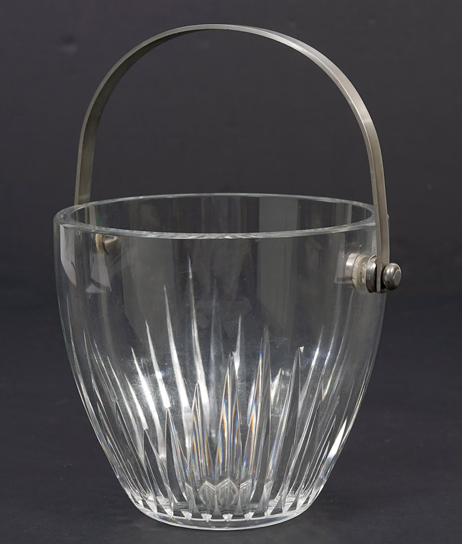 Baccarat Crystal Ice Bucket With Swing Handle: Baccarat crystal ice bucket with stainless steel swing handle. Measures 5"H x 6.5"W. Condition report: Good condition, please examine all photos closely. Contact C. Biddle Auction Gallery for more det