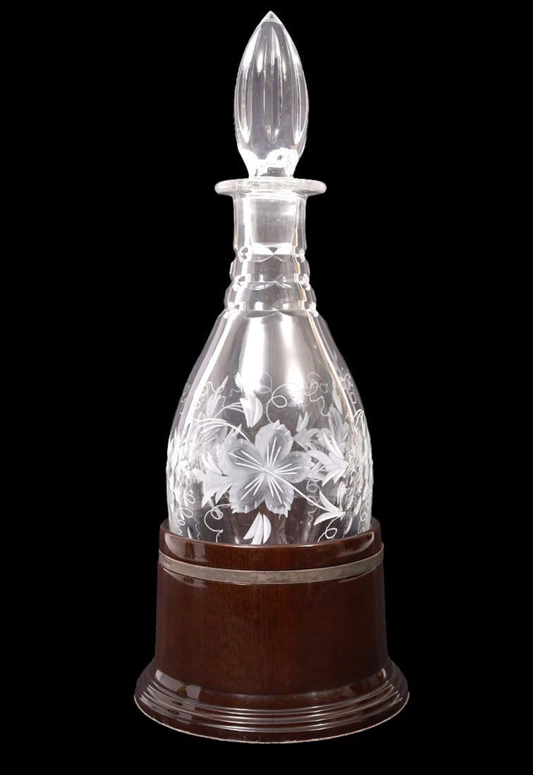 Royal Doulton Crystal Wine Decanter w/ Stand: Royal Doulton crystal wine decanter features cutouts, etched leaves and vine patterns and rests on custom round stand. Etched hallmark underside. Overall measures 13.5"H x 5.5"W. Condition report: Goo