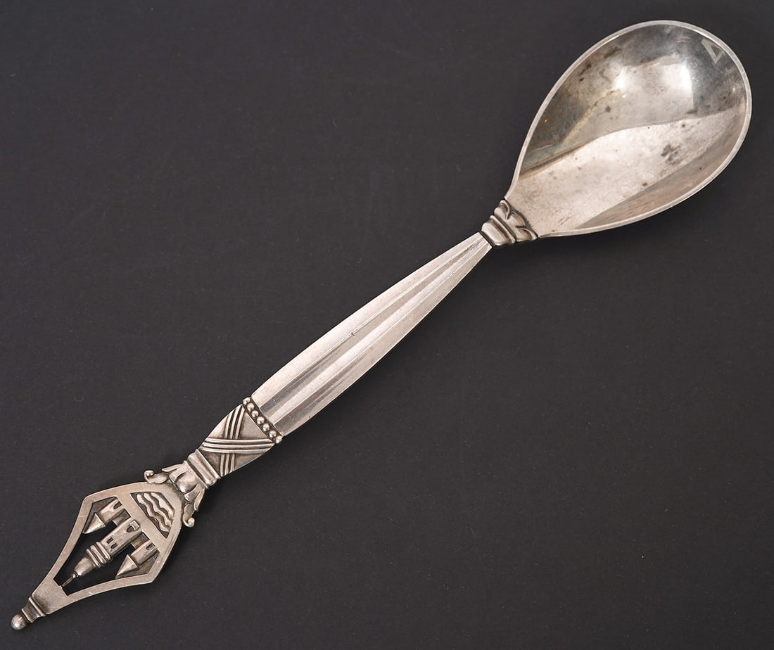 Georg Jensen Sterling 800 Yr Anniversary Spoon: Georg Jensen sterling silver 800 year anniversary spoon with an ornamental design and the dates "1167 / 1967" on back. Approx 6.5" long. Weight - 34.4g. Condition report: Good condition, please examin