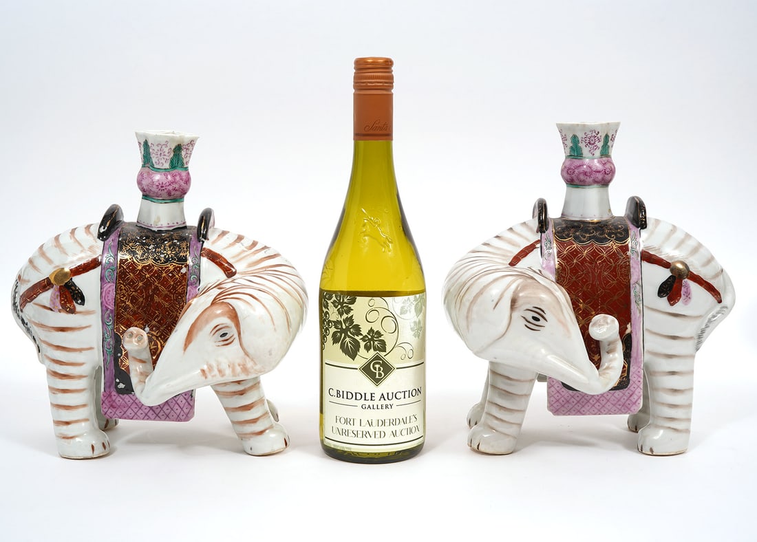 Pr. Mottahedeh 'Winterthur' Elephant Candlesticks: Pair of Mottahedeh 'Winterthur' porcelain elephant candlesticks. Measures 7.5"L x 7"W x 9.5"H. Condition report: Minor paint loss, please see all photos. Contact C. Biddle Auction Gallery for more det