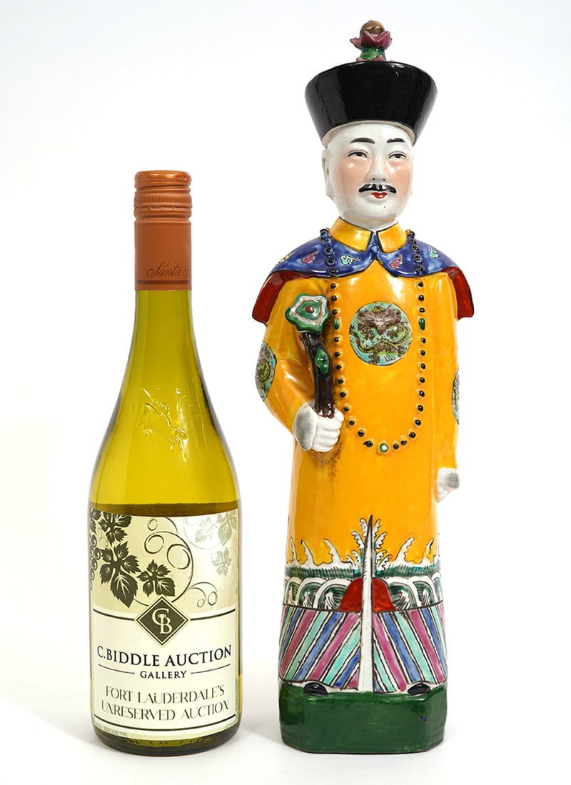 Chinese Porcelain Figure of a Standing Male: Chinese porcelain figure of a standing male, possibly an official as indicated by the yellow robe which is reserved for high officials. The marks on the bottom are Chinese characters that form a reign