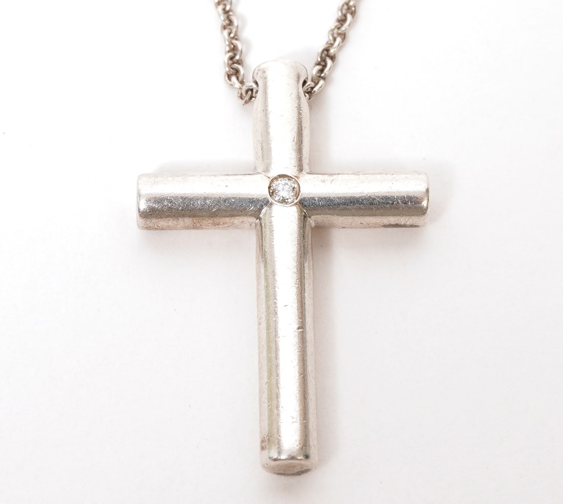 Tiffany & Co Sterling Diamond Cross Necklace: Tiffany & Co sterling silver cross necklace with single 1pt diamond. Measures 21" long. Weight - 8.4g. Includes Tiffany & Co pouch. Condition report: Good condition, please see all photos. Contact C.