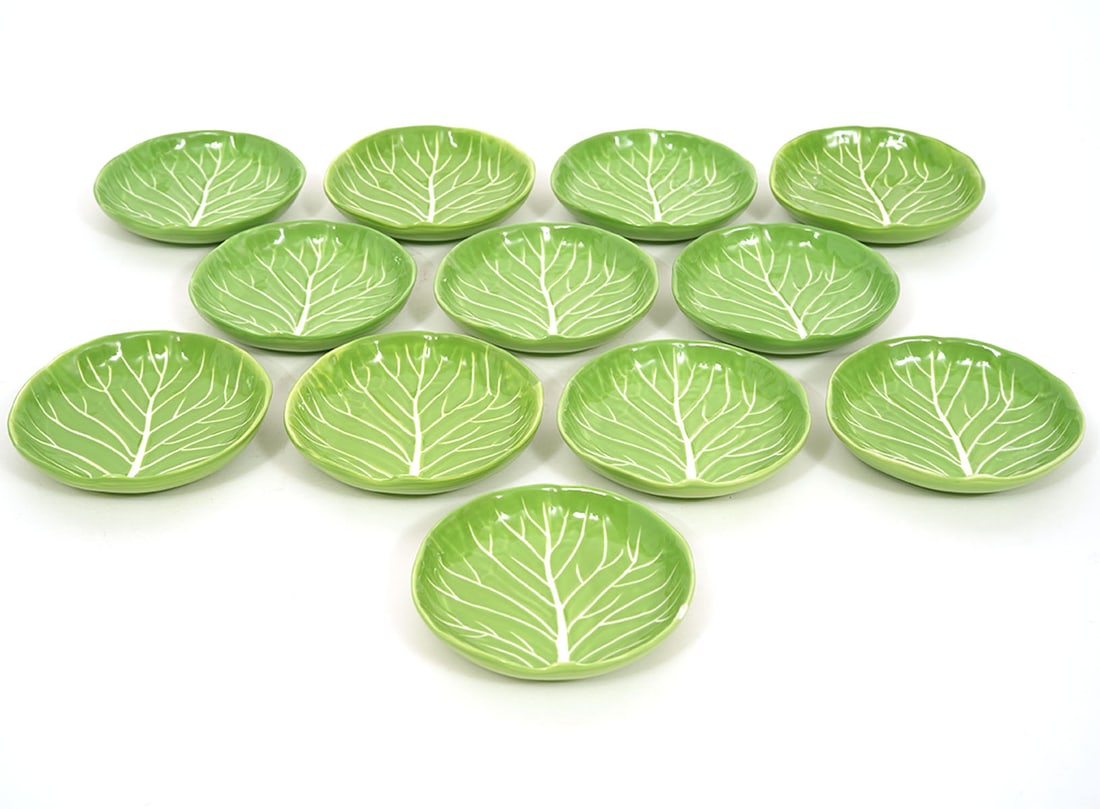 12 Dodie Thayer for Tory Burch Canape Plates: 12 Dodie Thayer for Tory Burch lettuce ware hand detailed stoneware canape plates are marked on underside 'Dodie Thayer for Tory Burch'. Measures 3.75"W. Condition report: one tiny flake to one rim, p