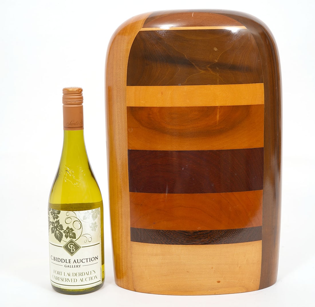 Paul LaMontagne Modernist Art Wood Vase: Paul LaMontagne mixed wood vase has a curvilinear shape with inlays. Artist's signature is incised on underside. Measures 16"H x 9"L x 4.25"W. Condition report: good condition, please see all photos.C