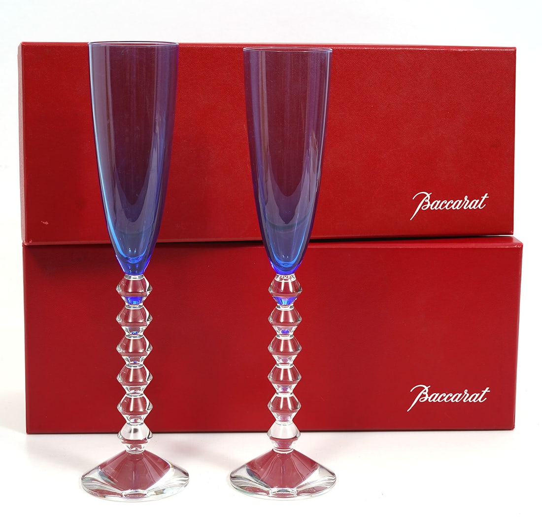 Pr. Baccarat Vega Flutissimo Champagne Flutes: Pair of vintage blue sapphire crystal Baccarat Vega Flutissimo Champagne Flutes with signature geometric stacked stems. Measures 11.25"H and both include original Baccarat boxes. Condition report: goo