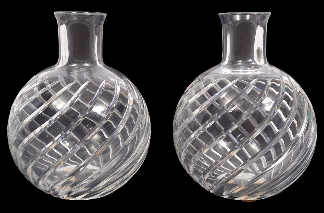 Pr. Baccarat Cyclades Crystal Vases: Pair of Baccarat Cyclades cut crystal bud vases with distinctive swirl designs on outer walls with a narrow neck. Marked Baccarat on underside. Measures 5"H x 3.75"W. Condition report: Good condition,