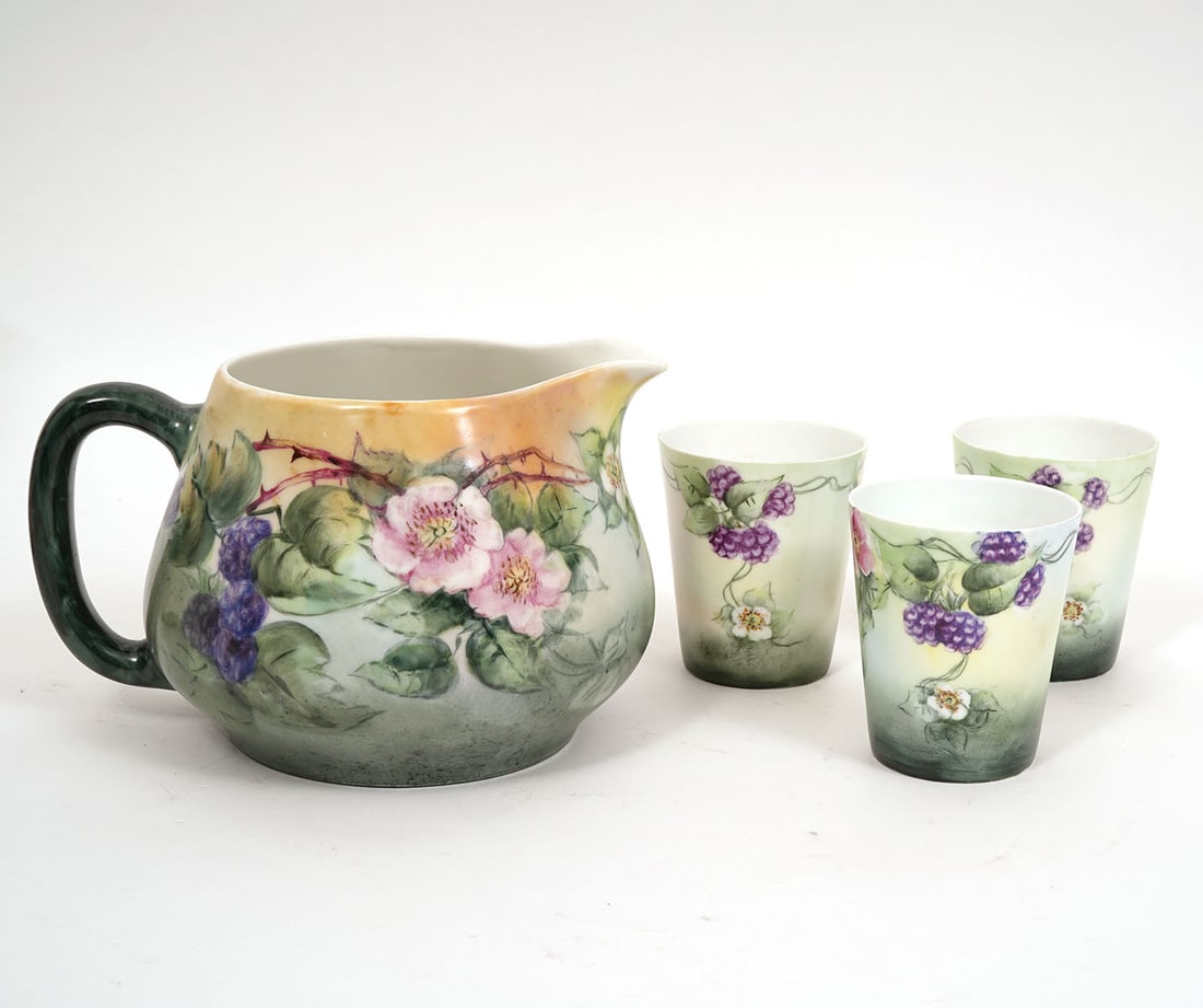 Haviland France Porcelain Pitcher and 3 Glasses: Haviland France porcelain pitcher and 3 porcelain glasses produced in Limoges, France are hand painted and marked on underside. Pitcher measures 5.5"H x 8.75"L x 6.5"W and glasses 3.75"H x 3.25"W.