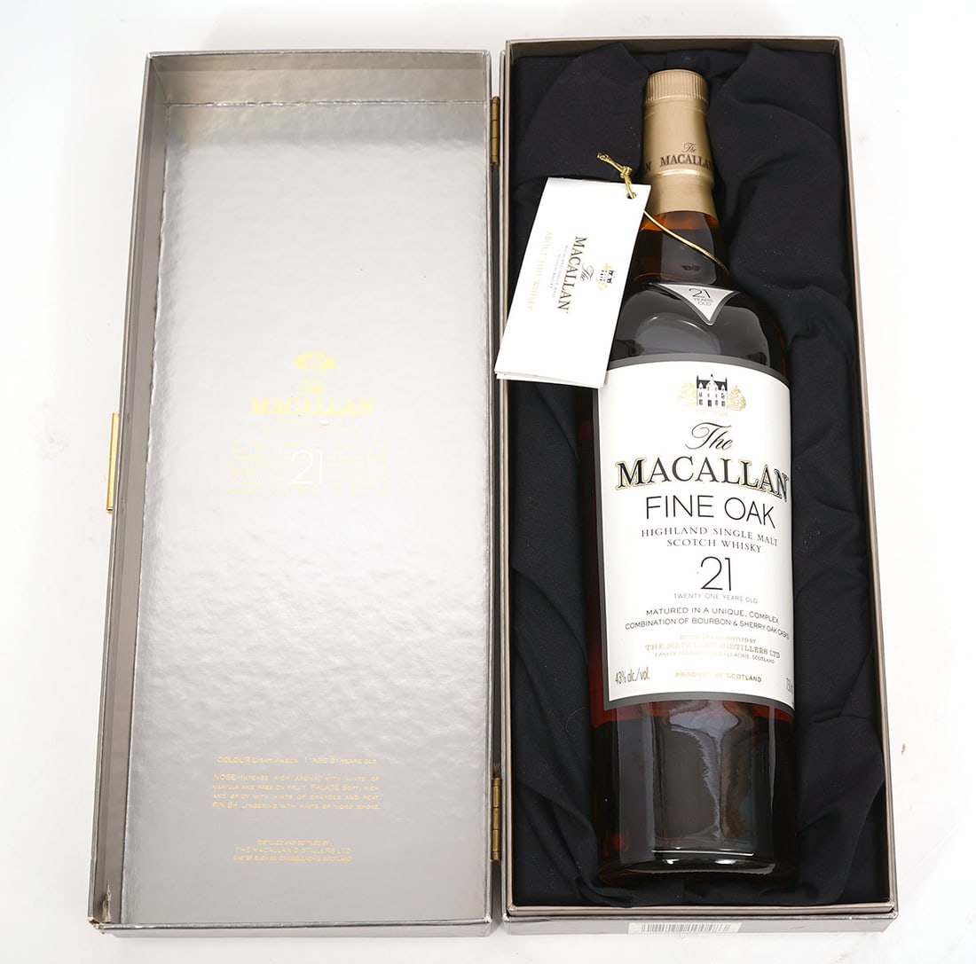 Macallan 21 Yr Old Single Malt Scotch Whisky: A bottle of Macallan 21 year old Single Malt Scotch Whiskey matured for a minimum of 21 years in a unique combination of European sherry oak, American sherry oak and American bourbon oak casks. The 'F