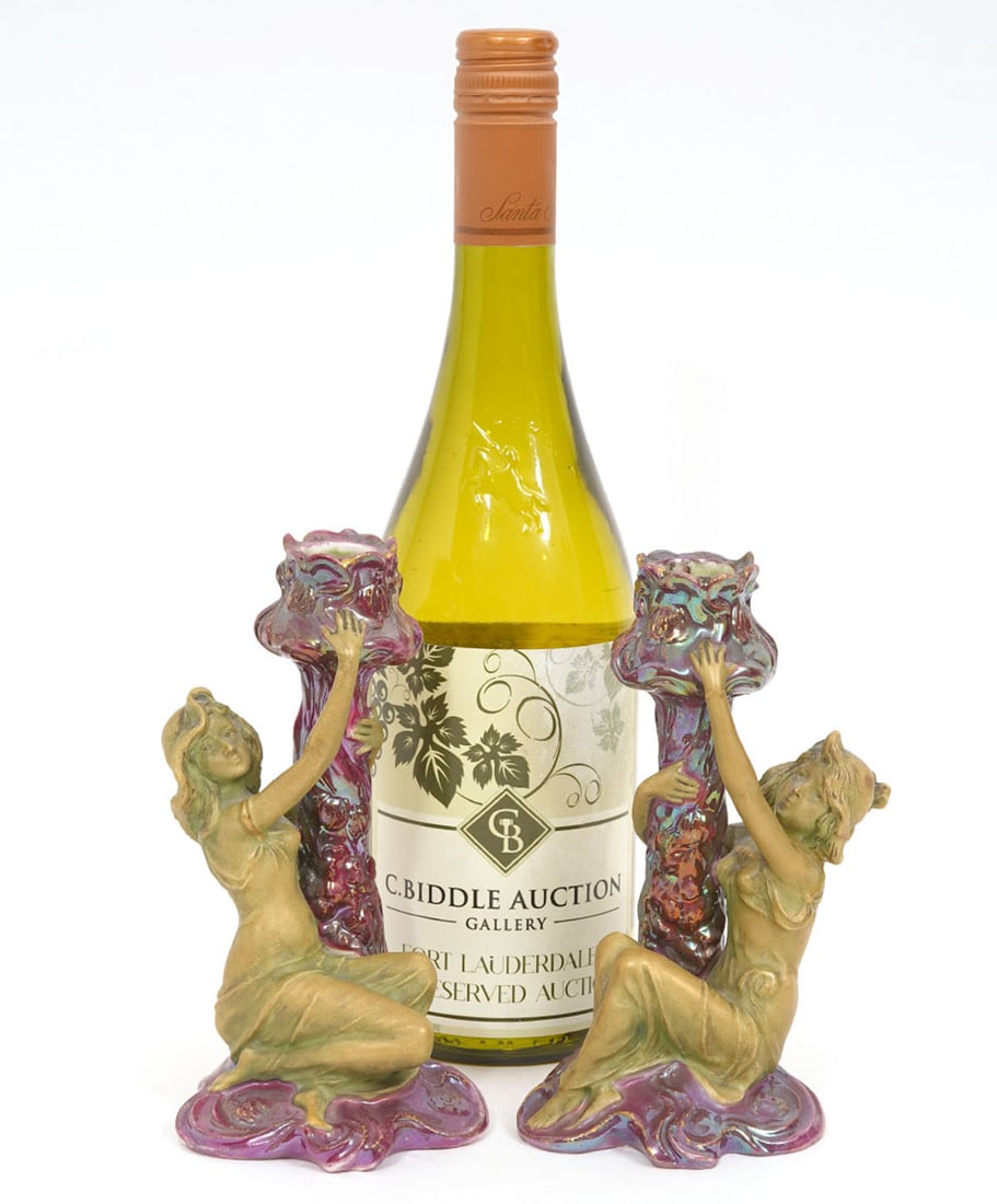 Pr. Antique Austrian Glazed Figural Candlesticks: Pair of antique Austrian glazed porcelain figural candlesticks features two women on purple bases. Marked on underside Made in Austria, manufactured by Turn-Wien. Measures 6.25"H x 3.25"L x 3"D. Condi