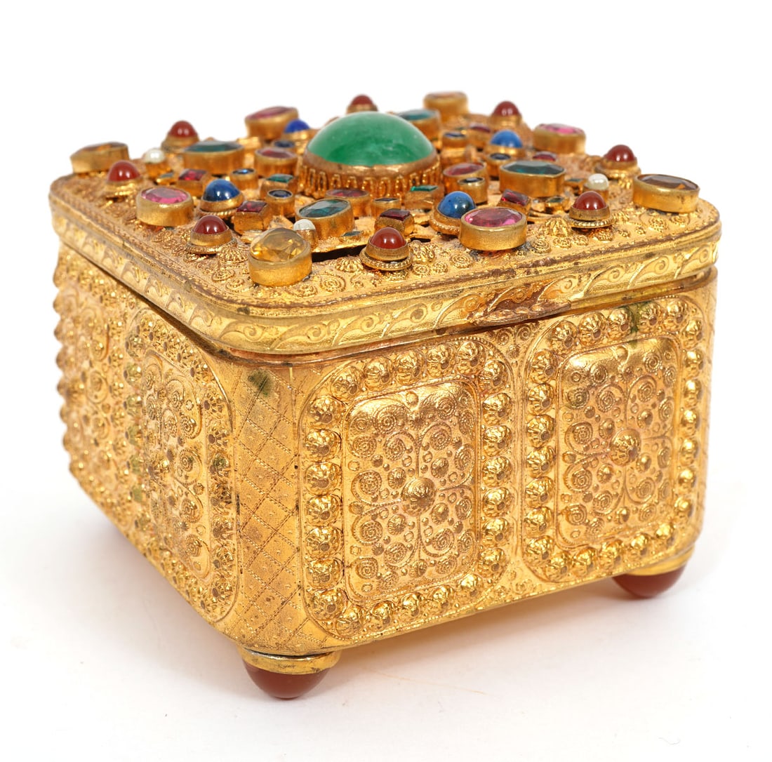 Austrian Antique Filigree & Repouse Jeweled Casket: Austrian antique filigree and repouse jeweled casket is raised on 4 cabochon feet and has a hinged lid embellished with vibrantly colored stones. Measures 3.25"L x 3.25"W x 2.75"H. Condition report: m