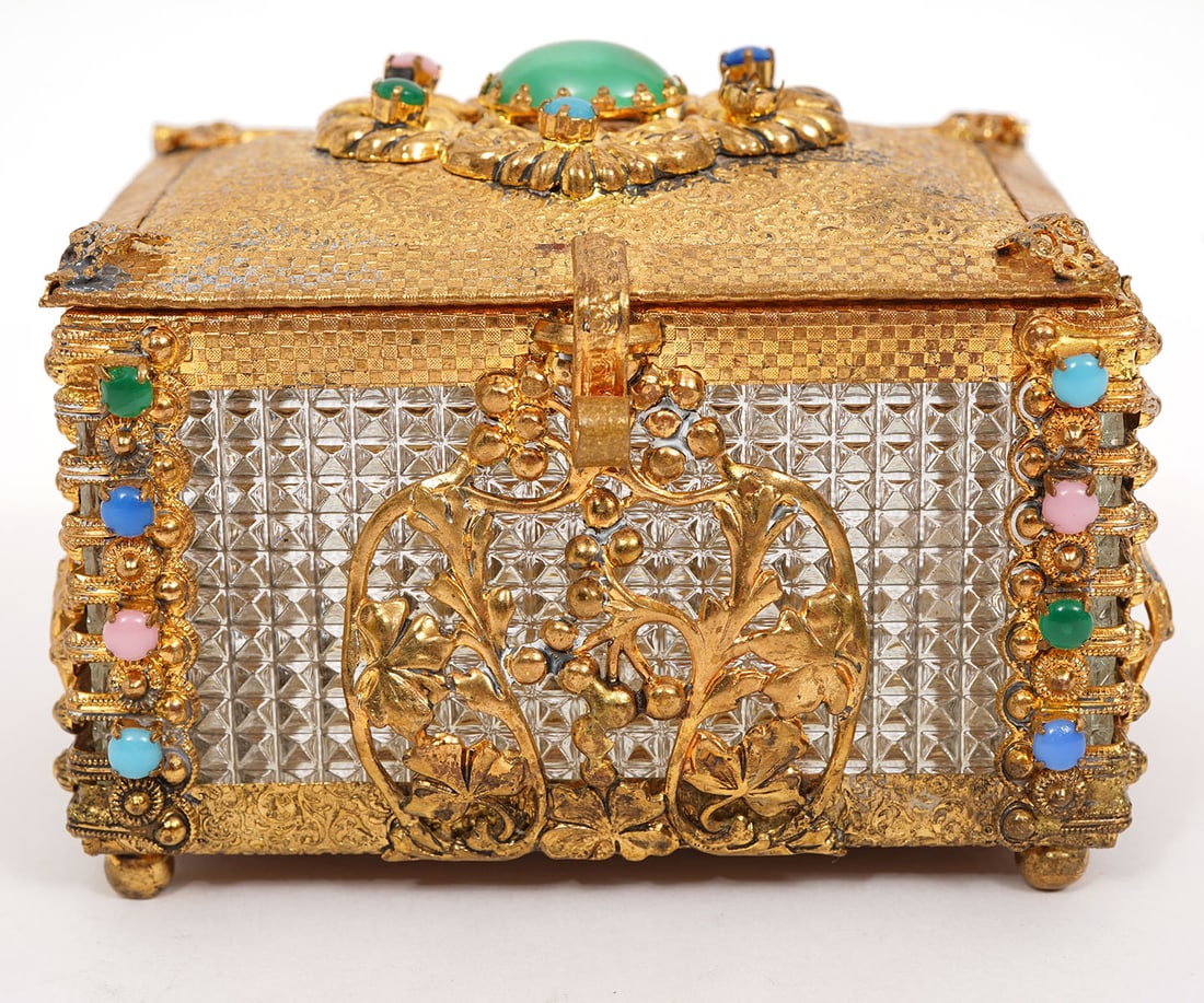 Vintage Gilded Metal Framed Jeweled Trinket Box: Vintage gilded metal framed and jeweled trinket box with beveled lucite side panels and gemstone embellishments on hinged lid and corners. It is raised on 4 small ball feet. Measures 3.5"L x 2.75"W x