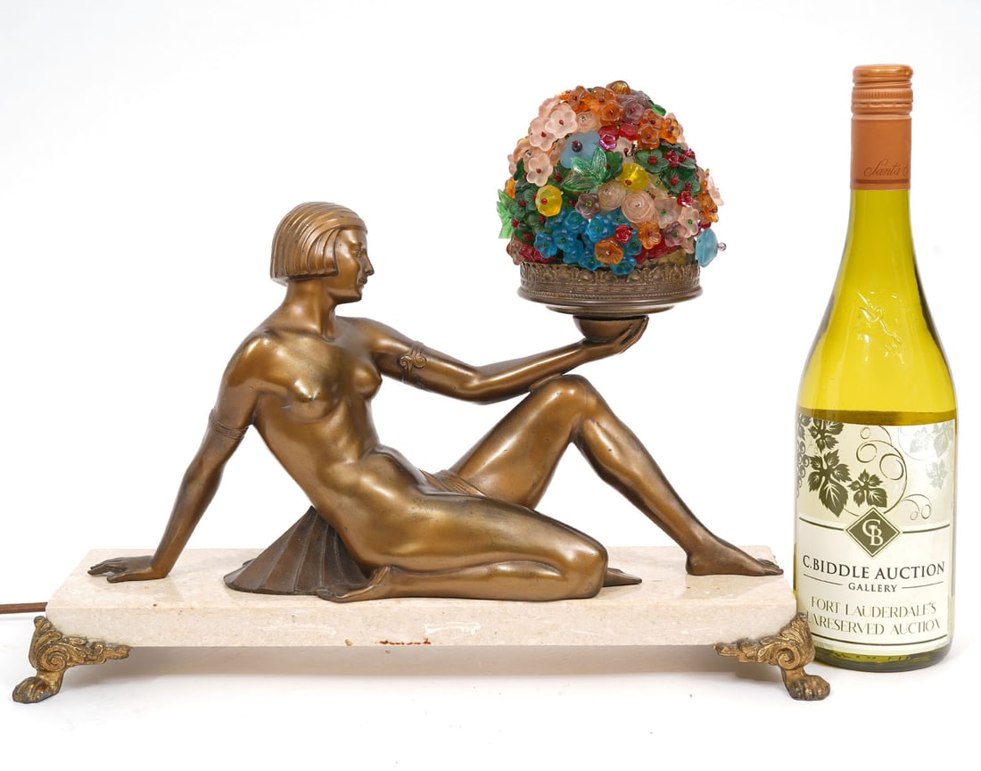 Art Deco Bronze Lamp with Flower Shade: Art Deco reclining bronze female figure holding lamp with intricate colored glass flower shade and mounted on marble base raised on 4 scrolled bronze feet. Measures 11.25"H total; 15.25"L x 5"W x 1.75