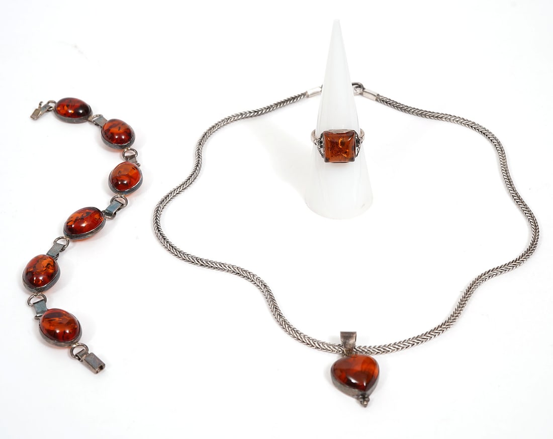 Sterling & Amber Necklace, Ring & Bracelet: Sterling pendant necklace with amber heart stone measures 17"L with 1" heart drop and is marked sterling. Sterling bracelet has six amber beads and measures 6.75"L. Sterling and amber ring is size 6.5