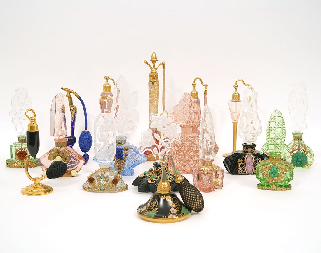17 Assorted Vintage Art Deco Perfume Bottles: Seventeen assorted vintage Art Deco glass perfume bottles includes a group of ten with frosted etched glass stoppers and bases that are embellished with floral motifs, gold tone filigree, glass stones
