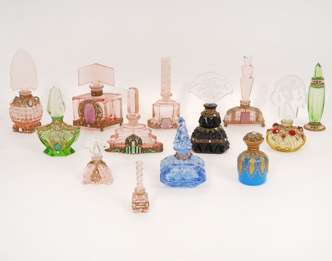 13 Art Deco Vintage Glass Perfume Bottles: Thirteen Art Deco glass vintage perfume bottles with frosted, etched and carved glass stoppers. Bases are carved and embellished with floral motifs, applied filigree metal, glass stones, and pearls. M