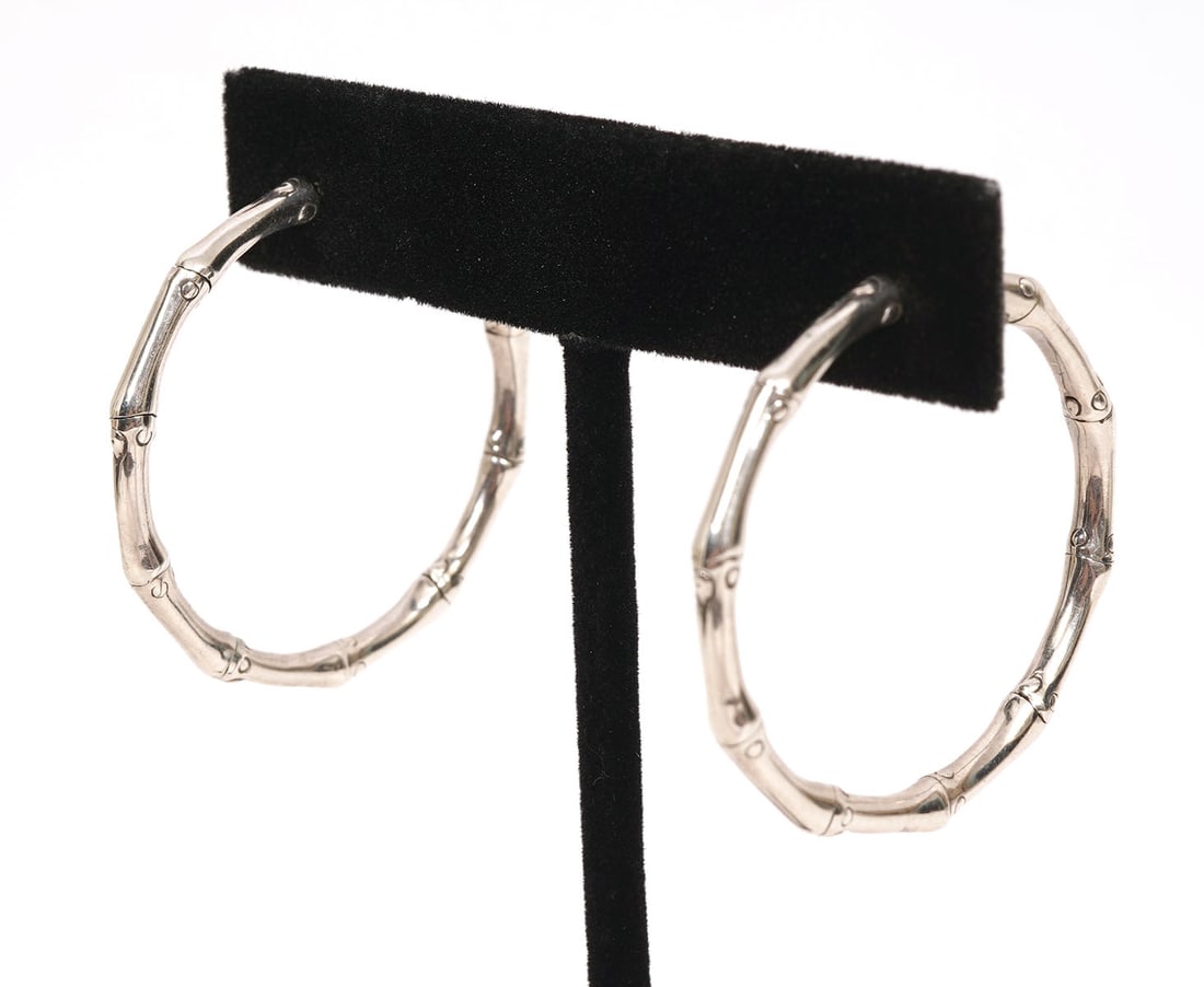 John Hardy Sterling Silver Bamboo-Style Earrings: John Hardy sterling silver bamboo-style hoop earrings are approx 1.25" diameter and weigh 10.1g. Condition report: Good condition, please examine all photos closely. Contact C. Biddle Auction Gallery