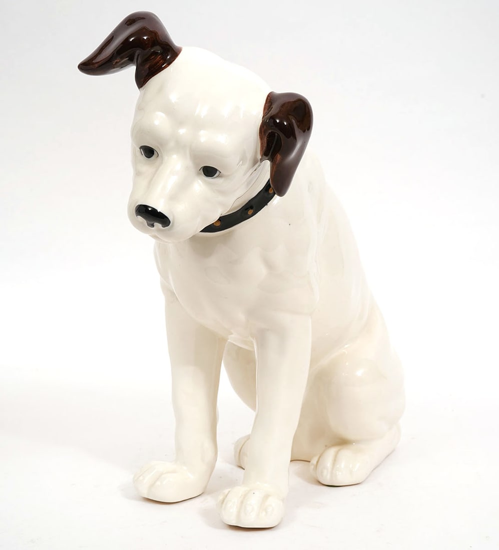 Nipper RCA Porcelain Coin Bank: Nipper RCA porcelain coin bank. Measures 11.5"H x 11.5"L x 5.5"W. Condition report: Good condition, please examine all photos closely. Contact C. Biddle Auction Gallery for more detailed information.