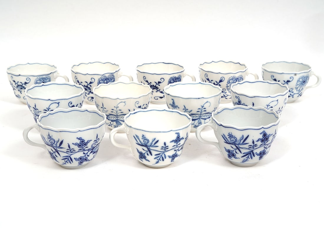 8 Meissen Blue Onion Porcelain Tea Cups: 8 Meissen Blue Onion porcelain tea cups measures 2.5"H x 4.5"W. Includes travel case. Condition report: Good condition, please examine all photos closely. Contact C. Biddle Auction Gallery for more de