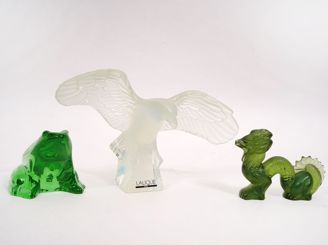 Group of 3 Crystal Figures Baccarat & Lalique: Group of 3 crystal figures includes a Baccarat crystal green frog (4"L x 3"W x 3"H); a Lalique opaque crystal eagle figure (8"L x 4"W x 5.5"H); a Lalique green dragon (4"L x 3"W x 1"H). Condition repo