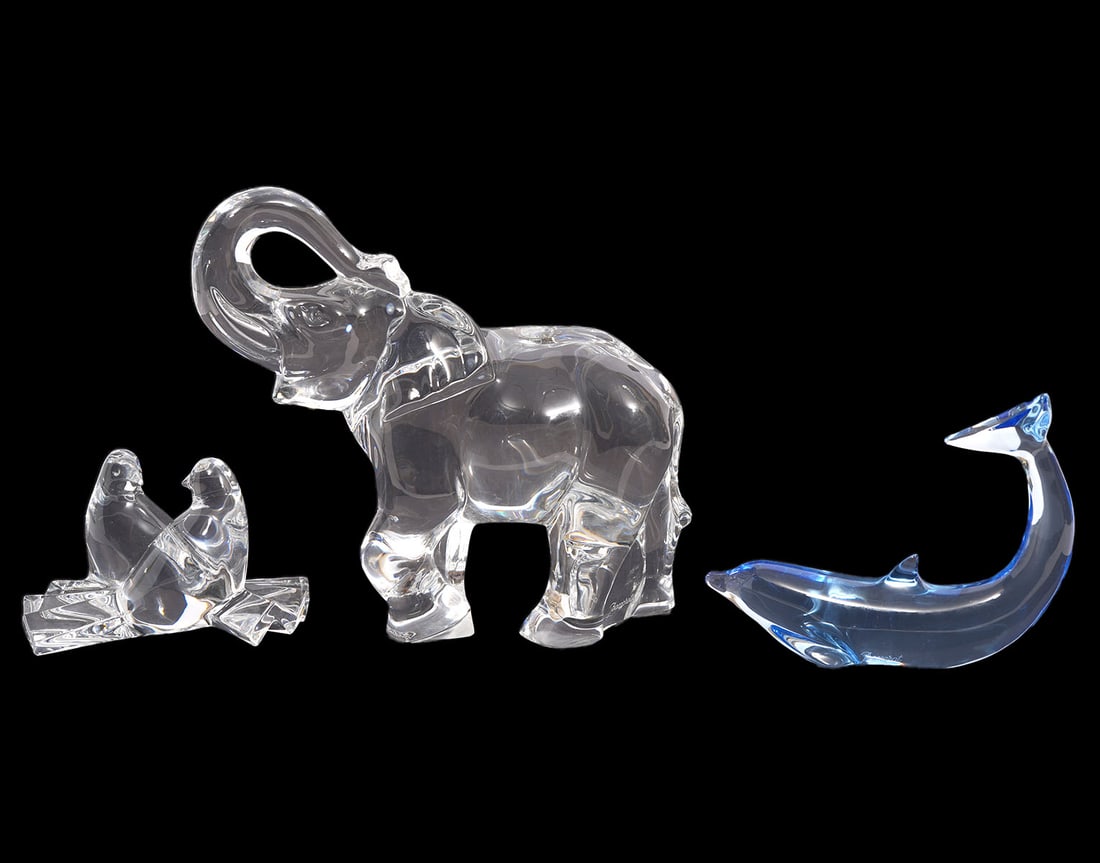 Three Baccarat Crystal Figures: Three Baccarat crystal figures includes an Elephant (6.5"L x 2.5"W x 6.5"H); Two doves (4"L x 2"W x 3"H); and blue dolphin (5"L x 1.5"W x 4"H). Condition report: Good condition, please examine all pho