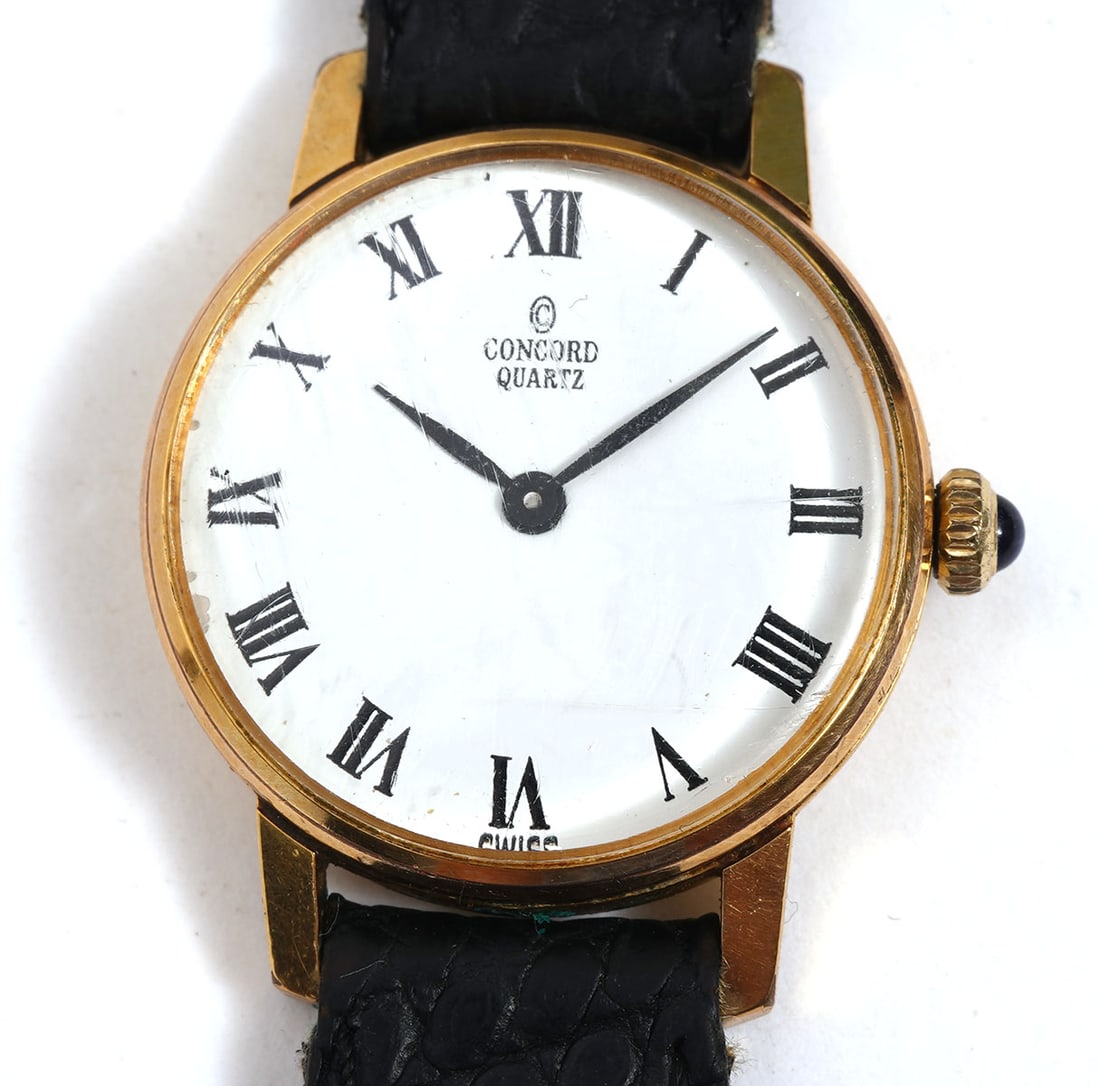 Concord Quartz Gold-Tone Watch Lizard Band: Concord quartz gold-tone watch with sapphire cabochon crown and black lizard band by Hadley-Roma. 22mm. Condition report: Good condition, please examine all photos closely. Contact C. Biddle Auction G