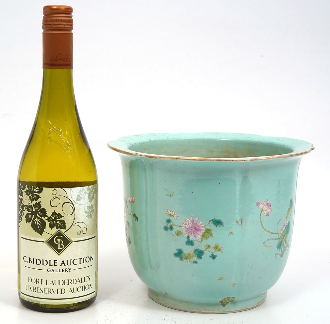 Chinese Hand-Painted Floral Motif Jardiniere: Chinese hand-painted floral motif jardiniere has a light turquoise background with various flora all-around. Measures 8.5"H x 6.5"W. Condition report: Hole drilled in center, please examine all photos