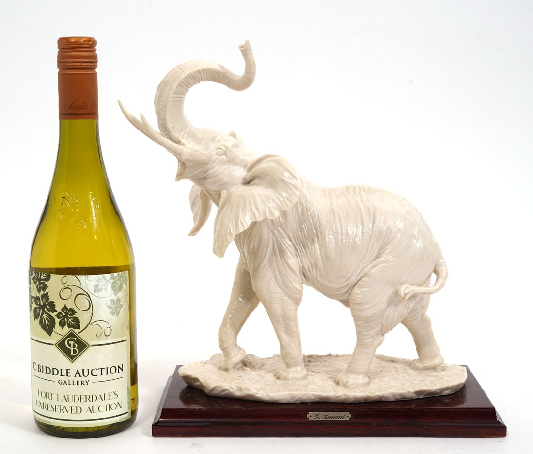 Giuseppi Armani Porcelain Elephant Figure: Giuseppi Armani porcelain elephant figure mounted on wood plinth is signed at base and labeled with brass plaque. Measures 10.5"L x 5"W x 11.5"H. Condition report: Good condition, please examine all p