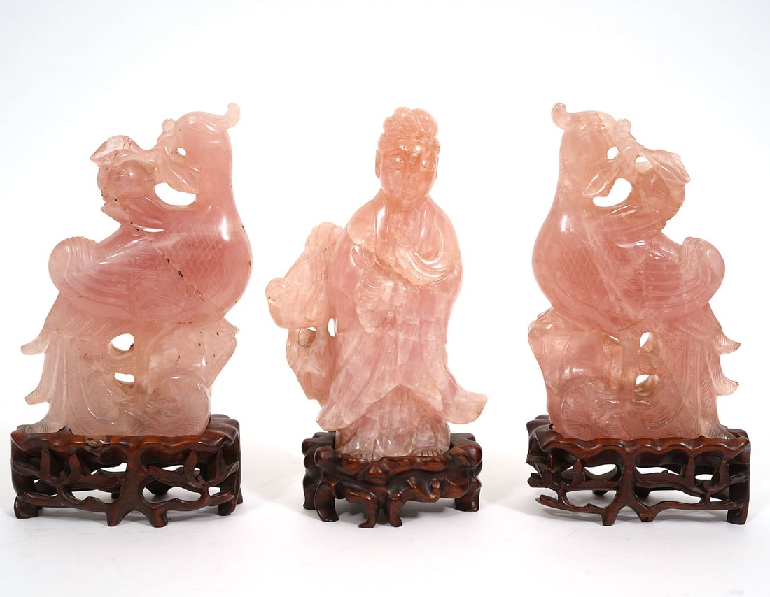Three Chinese Carved Rose Quartz Figures: Three Chinese carved rose quartz figures, includes two phoenix figures and a robed elder figure, each with custom wood bases and each measures approximately 8"H x 4.5"L x 2.5"W. Condition report: Repa