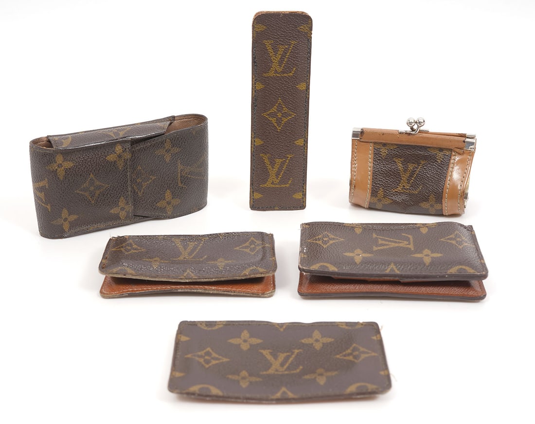 Group of Six Louis Vuitton Accessories: Group of six Louis Vuitton accessories includes a phone case (5"H x 2.5"W), wallet (4.5"L x 3"W), credit card case (4.5 x 3"W). comb in case (5.5"), bifold card case (4"L x 2.5"W), coin purse (2.5"H x