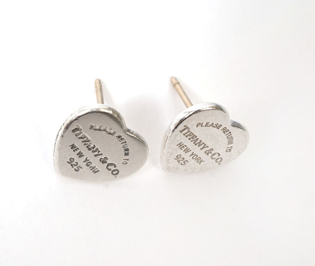 Tiffany & Co. Sterling Heart Earrings: Tiffany & Co. sterling heart stud earrings engraved on front Tiffany & Co. 925. They are .25"H each and total weight for the pair is 1.6 grams. Condition report: good condition, please see all photos.