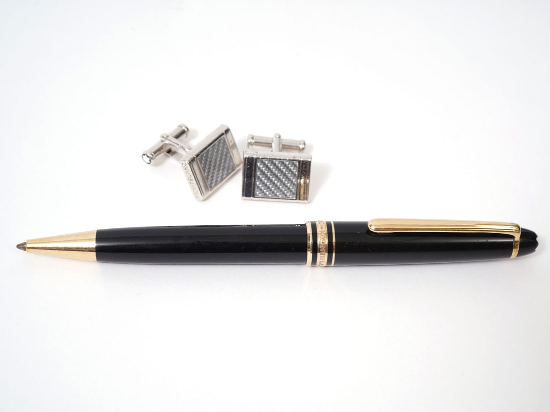 Montblanc Silver Tone Cufflinks & Meisterstuck Pen: Pair of Montblanc silver tone cufflinks with checkered inlay, marked on underside. Measures .5" x .75". Montblanc Meisterstuck Classique Ballpoint Pen in deep black resin with gold plated details. Mea