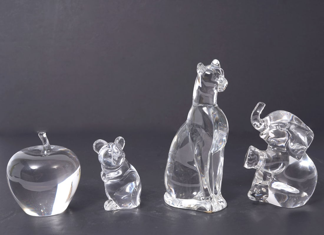 Group of Four Signed Crystal Paperweights: Group of four crystal paperweights signed includes a Daum mouse (1.75"L x 2"W x 3"H), Lenox elephant (3.5"L x 2.5"W x 4.5"H), Cat (3"L x 2'W x 6"H), apple (3"W x 3.5"H). Condition report: Good conditi