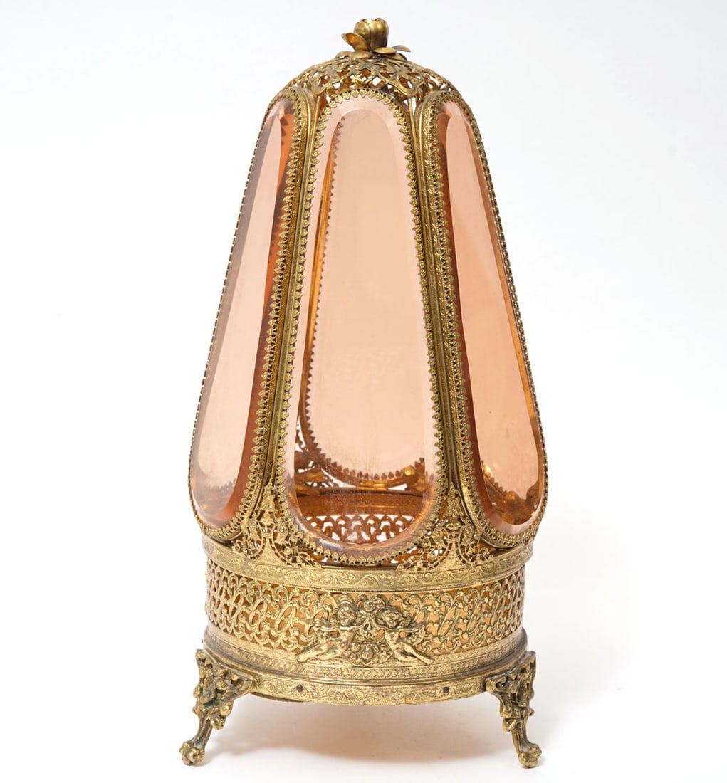 Vintage Hollywood Regency Jewelry Display Case: Vintage six sided hexagonal jewelry display casket with beveled amber glass encased with ornate filigree gilt ormolu, raised on three decorative feet. There are small gilt birds on each of the panels 