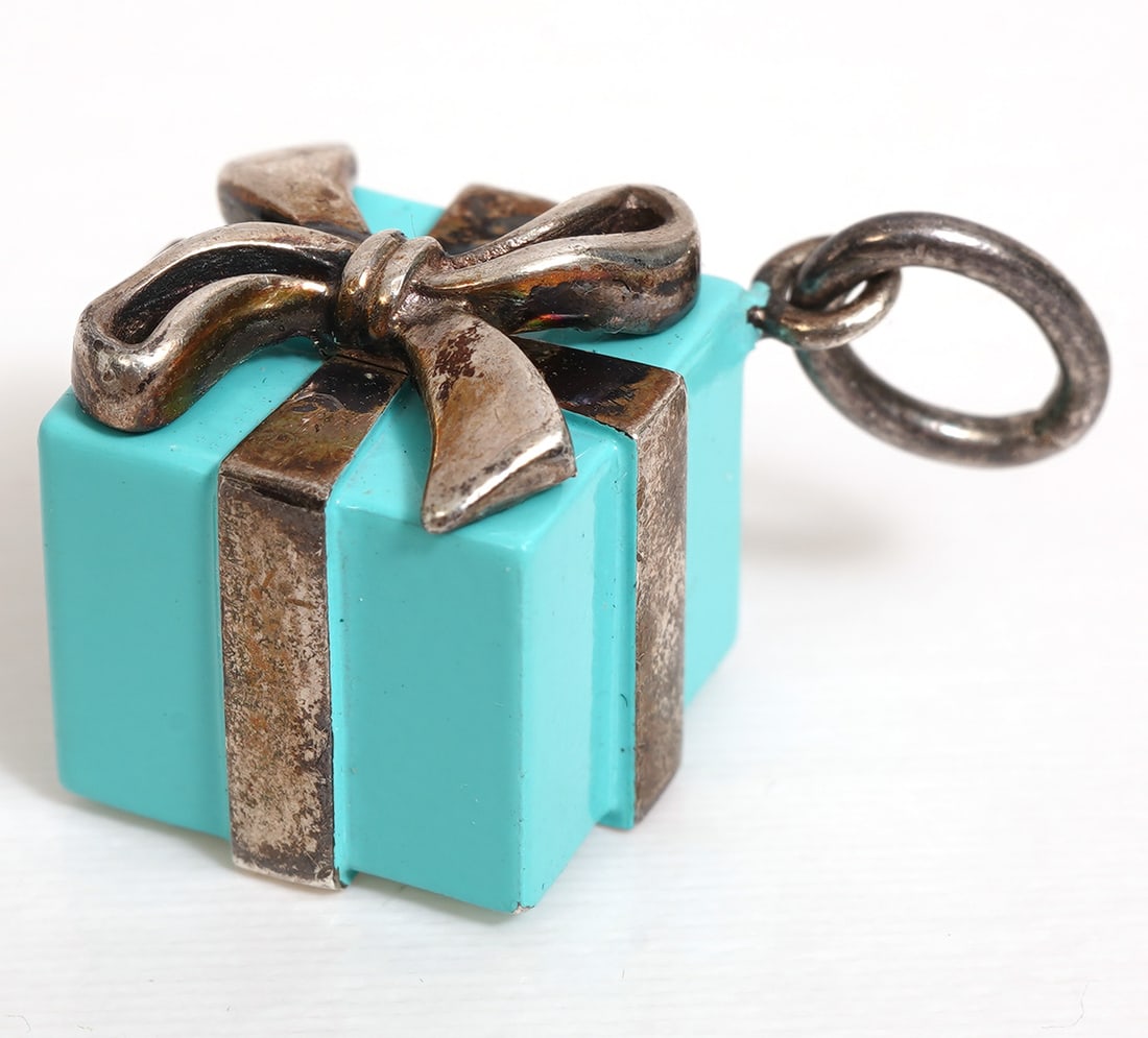 Tiffany & Co. Sterling 'Blue Box' Charm: Tiffany small sterling 'Blue Box' charm with sterling bow marked 'Tiffany AG 925 Germany', weighs 8.1 grams and measures 3/8" x 3/8". Condition report: good condition, please see all photos. Contact