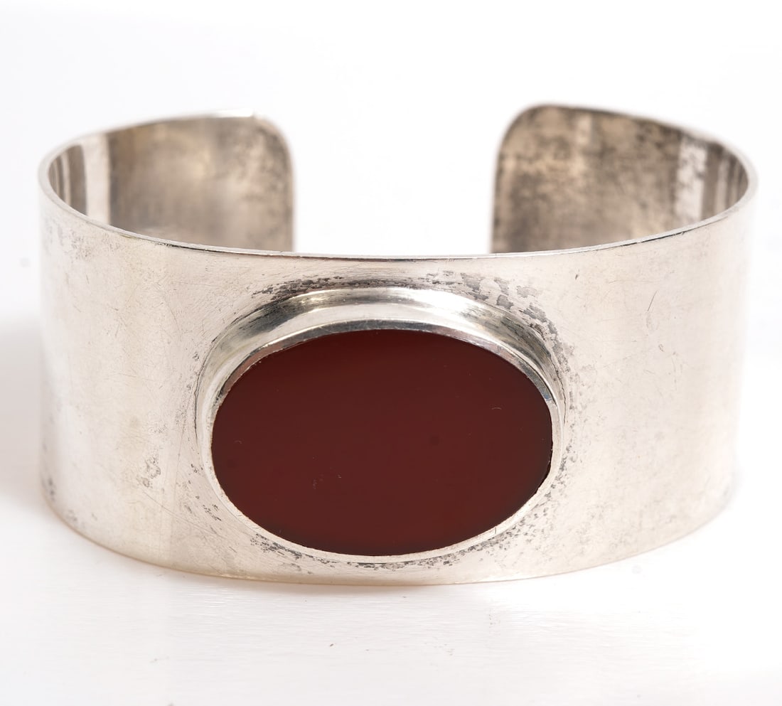 Sterling Cuff Bracelet with Carnelian Stone: Sterling silver cuff bracelet has an oval carnelian stone and measures 5.5" inside end to end with a .75" opening. Marked 'Sterling' and has a personal message inscribed on inside signed 'Love Mom