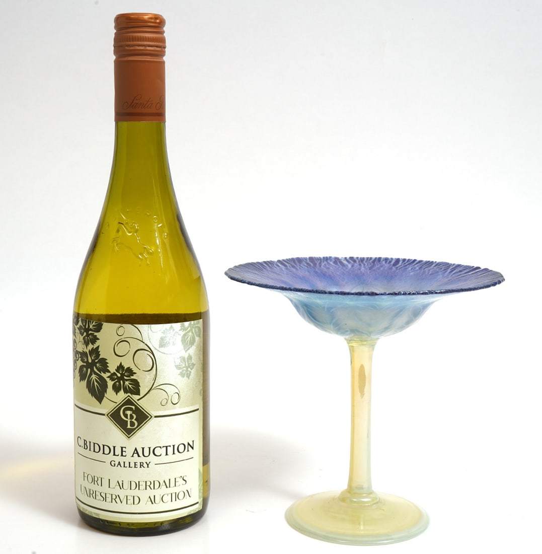 Tiffany Favrile Opalescent Art Glass Compote: Tiffany Favrile opalescent art glass compote features blue and green opaque hues, butterfly decoration on top and is signed on the underside. Measures 6"H x 6.5"W. Condition report: Good condition, pl