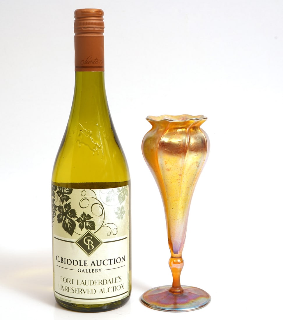 Tiffany Favril Iridescent Glass Tulip Vase: Tiffany Favril Iridescent Glass Tulip Vase is signed on underside. Measures 7.75"H x 2.75"W. Condition report: Good condition, please examine all photos closely. Contact C. Biddle Auction Gallery for 