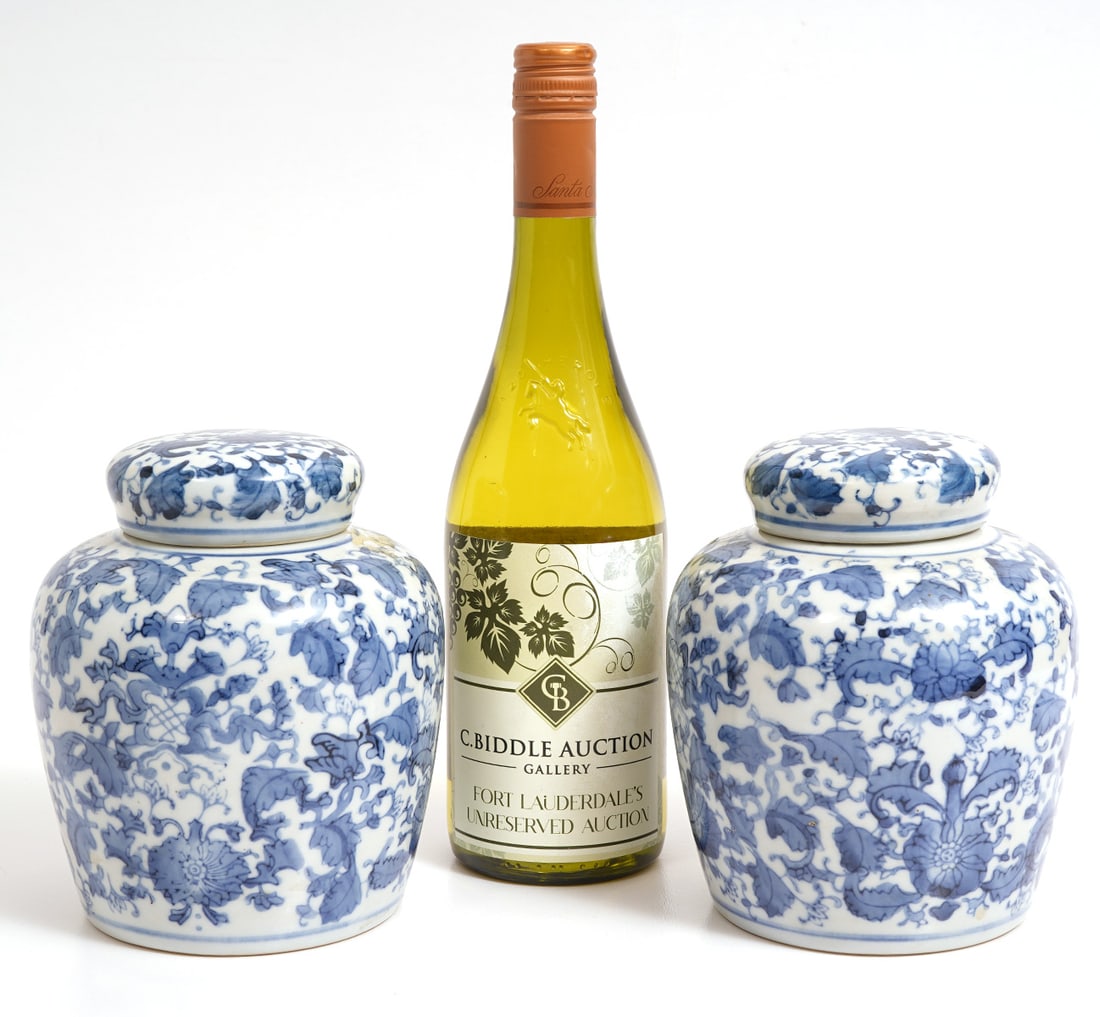 Pr. Blue & White Floral Ceramic Ginger Jars: Pair of blue and white floral ceramic lidded ginger jars that measure 6.5"H x 5"W. Condition report: good condition, please see all photos. Contact C. Biddle Auction Gallery for more detailed informat