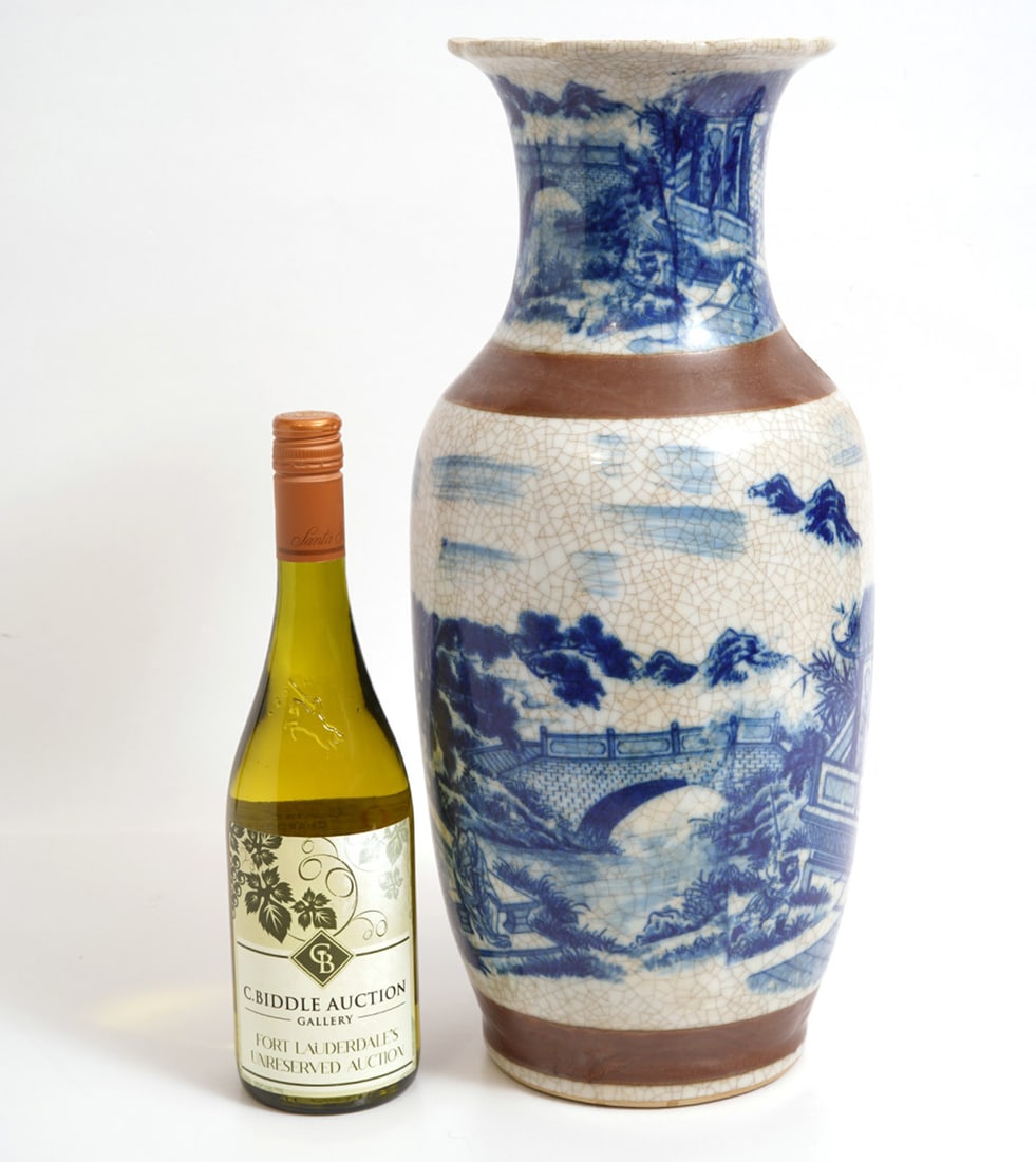 Chinese Blue & White Porcelain Vase: Chinese blue and white porcelain vase features water and mountain landscapes. It has an overall crackle finish and high relief bands in brown glaze around the neck and the bottom. Measures 17 5/8"H x 