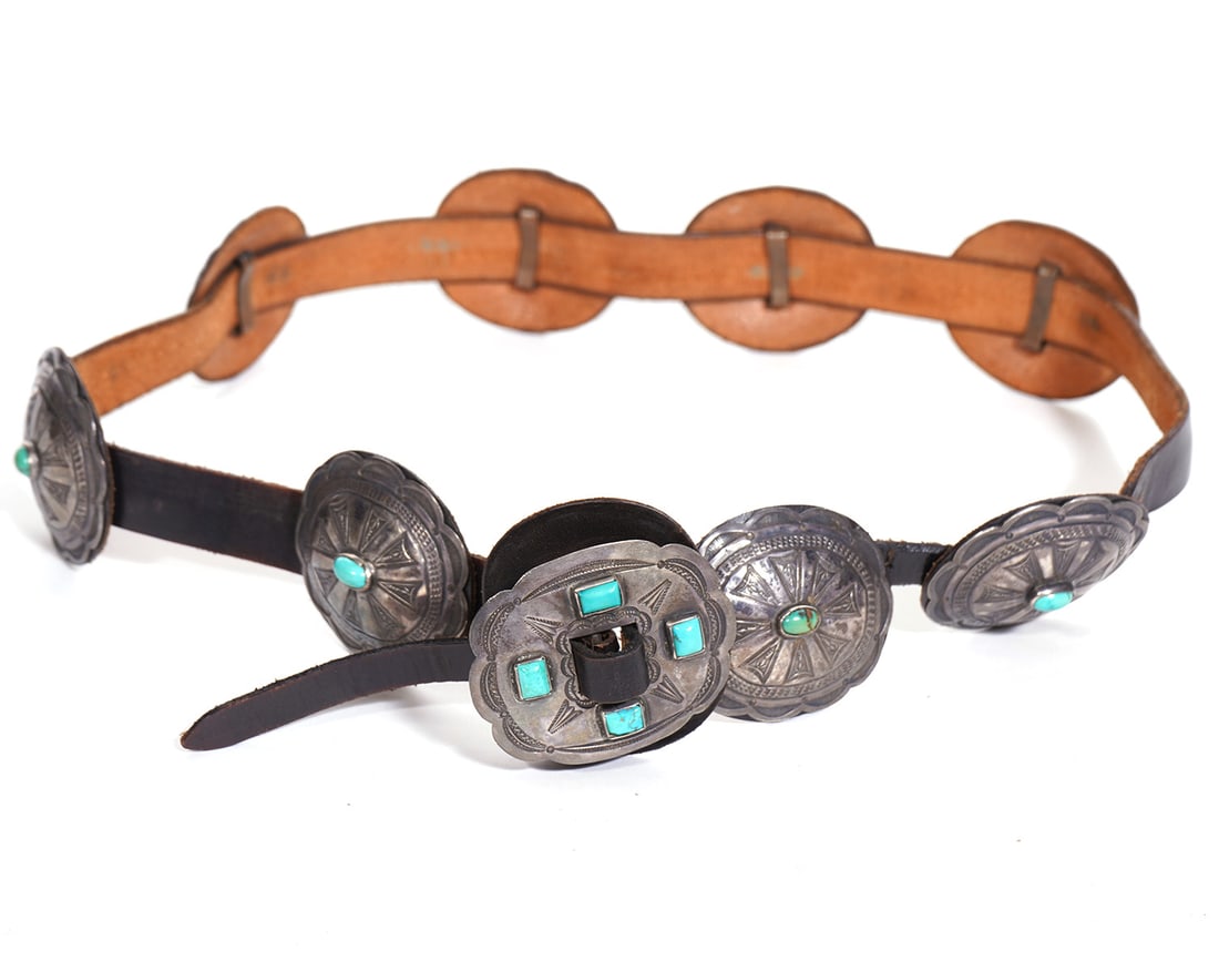 Rustic Oval Silver & Turquoise Concho Belt: Belt has rustic oval silver conchos with turquoise stones on black leather. The 9 silver conchos are accented with the colorful turquoise stones. Measures approximately 39"L; conchos 2"L x 2.5"H. Cond