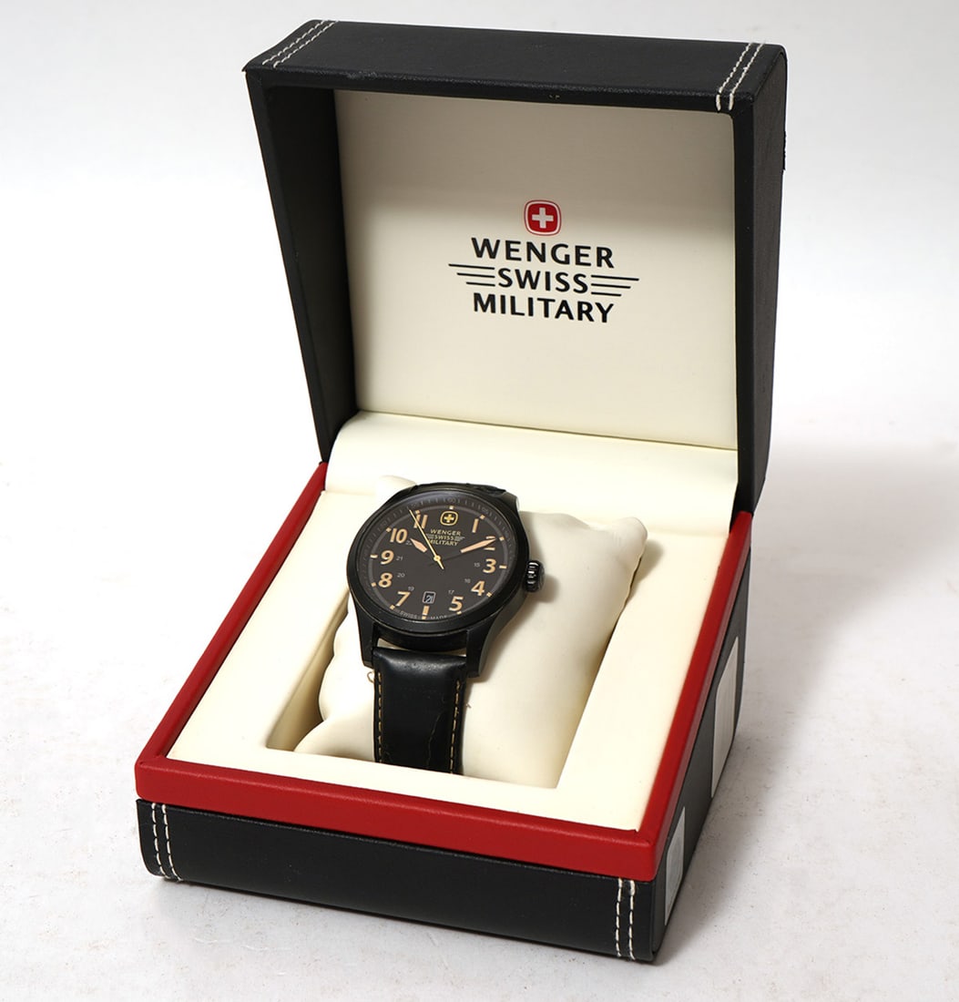 Wenger Swiss Military Watch: Wenger Swiss Military Watch has a black face, black strap and includes original box and Instruction Manual. Condition report: good condition, has not been tested for accuracy, please see all photos. C