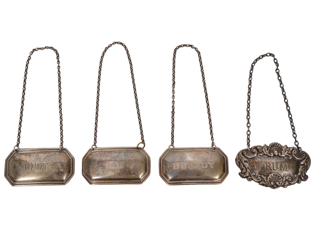 Group of 3 Tiffany & Co Sterling Liquor Tags Plus: Group of three Tiffany & Co sterling silver liquor tags includes 'Vodka', 'Gin' and 'Brandy' and one additional 'Rum' silver tag. Each has English silver hallmarks and each measure about 2" wide. Tota