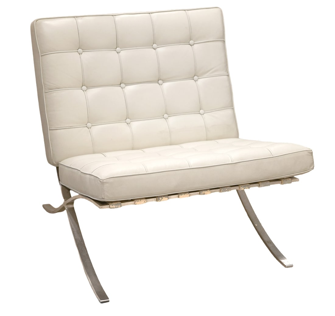 Knoll Barcelona Style of White Leather Chair: Knoll Barcelona style chair with stainless steel frame has back and seat cushions in white leather. Measures 28.5"H x 29.5"W back; 20.25"D x 14"H x 29.5"W seat; cushions measure approx. 21.5"W x 31"L 