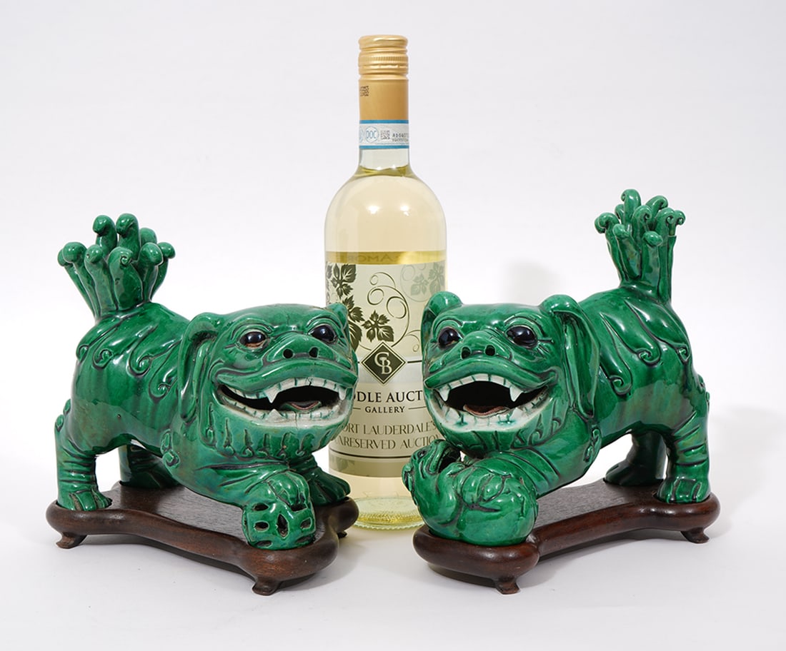 Chinese Green Glaze Left Right Porcelain Foo Dogs: Chinese green glazed left right porcelain foo dogs seated on custom wood stands. Each measures 7.5"L x 5"W x 8"H. Condition report: Good condition, please examine all photos closely. Contact C. Biddle